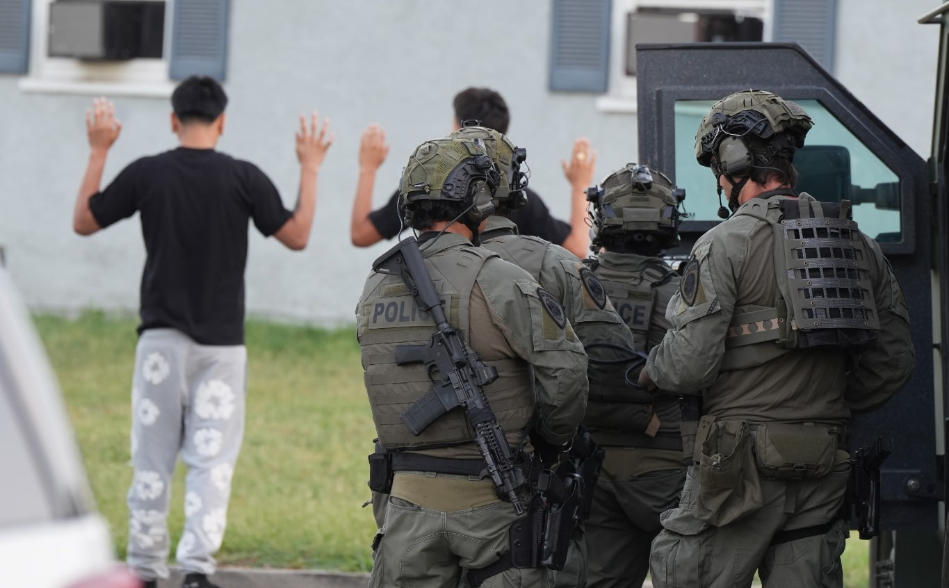 San Bernardino police detain two men on July 16, 2026, as part of a sweep related to a 2021 fatal shooting in the city. Officers served search warrants in several cities. (Courtesy of San Bernardino Police Department)